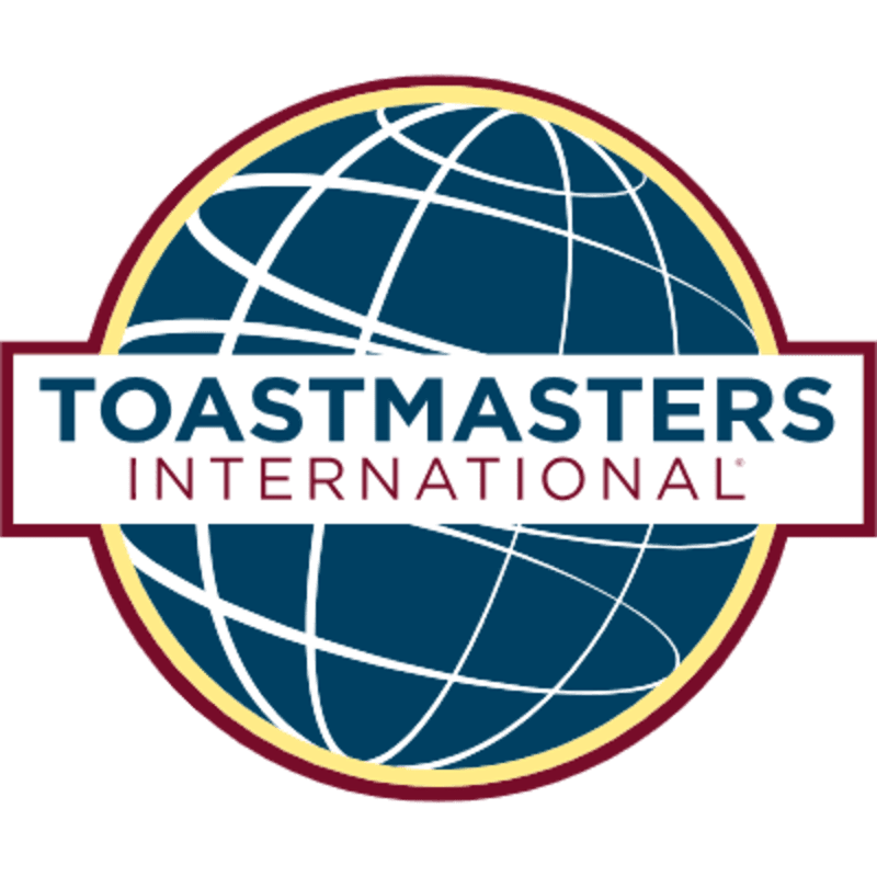 A white rectangular banner with the text "TOASTMASTERS INTERNATIONAL" sits in the foreground over a blue stylized globe with white grid lines and a maroon and gold border in the background.