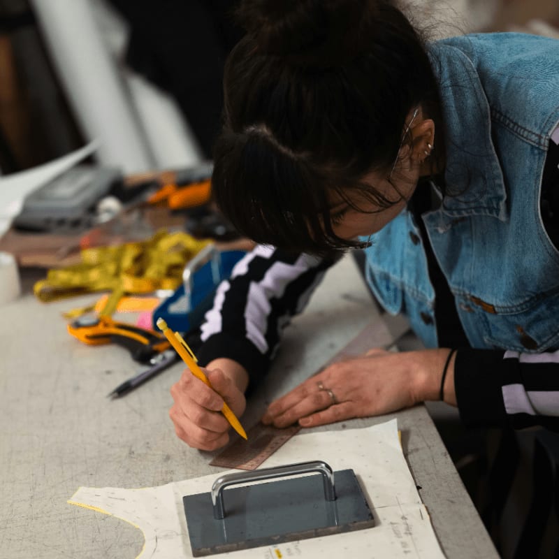 A person drawing on a clothing pattern