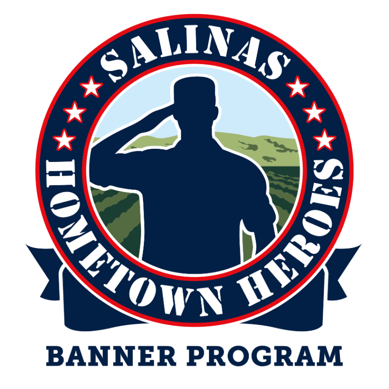 A dark blue silhouette of a saluting soldier stands in the foreground against a background of rolling green hills and a blue sky, all enclosed within a circular emblem reading "SALINAS HOMETOWN HEROES."