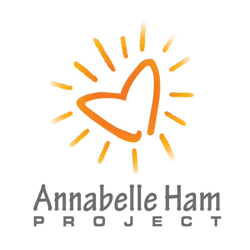 An orange heart-shaped sun with radiating rays sits above the text "Annabelle Ham PROJECT" against a plain white background.