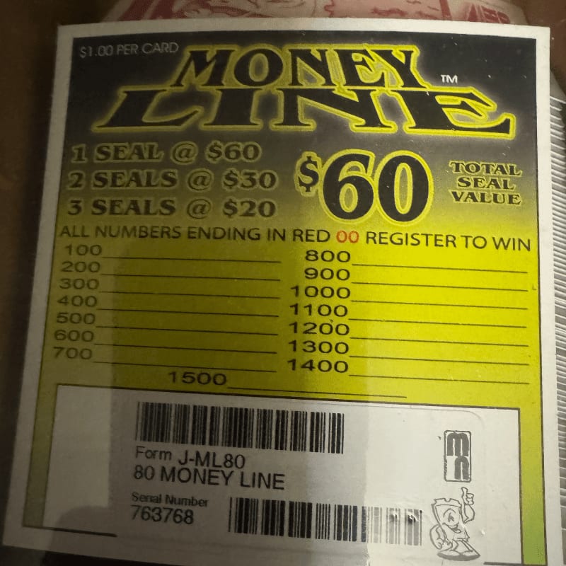 A "Money Line" lottery ticket with yellow and black text sits against a blurred, neutral background.