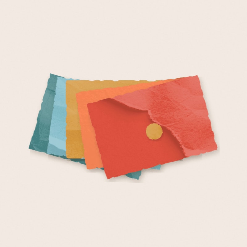 Stacked pieces of torn, colorful paper in blue, yellow, and red sit against a plain, light beige background.