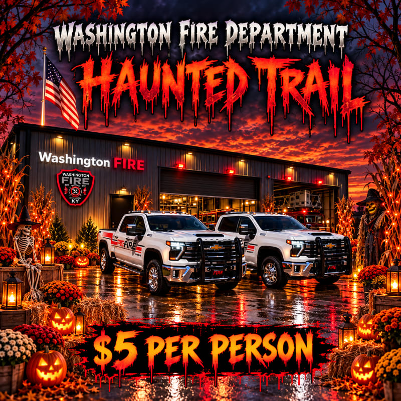 Two white fire department trucks sit in the foreground of a fire station, surrounded by Halloween decorations, under a dramatic red sunset sky.