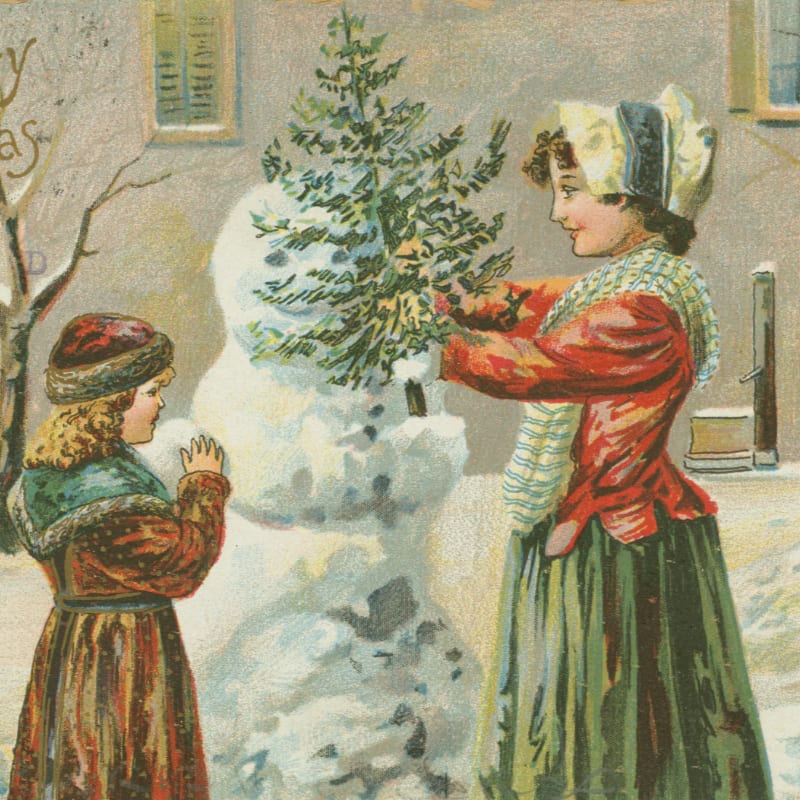 Two people building a snowman in winter