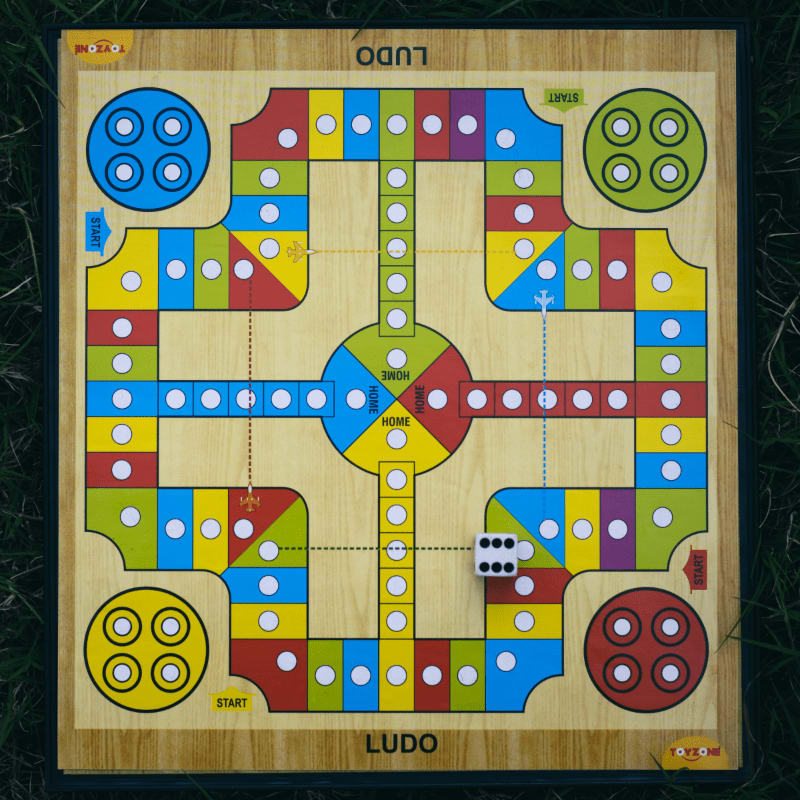 a wooden board game on the grass