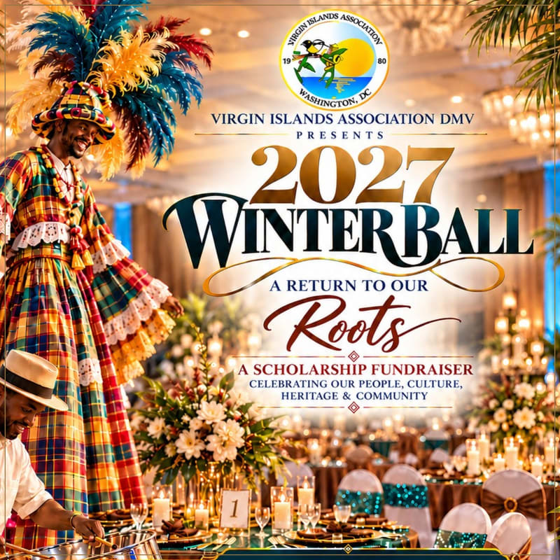 A man in a colorful Caribbean costume stands in the foreground of a lavishly decorated ballroom set for a scholarship fundraiser.