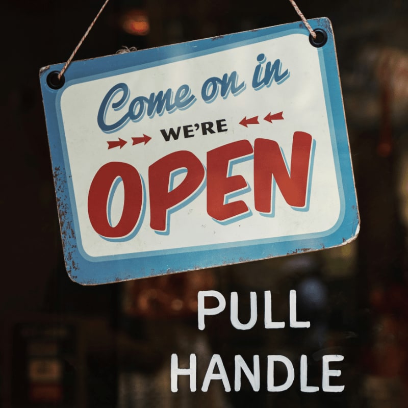come on in we're open signage on glass panel