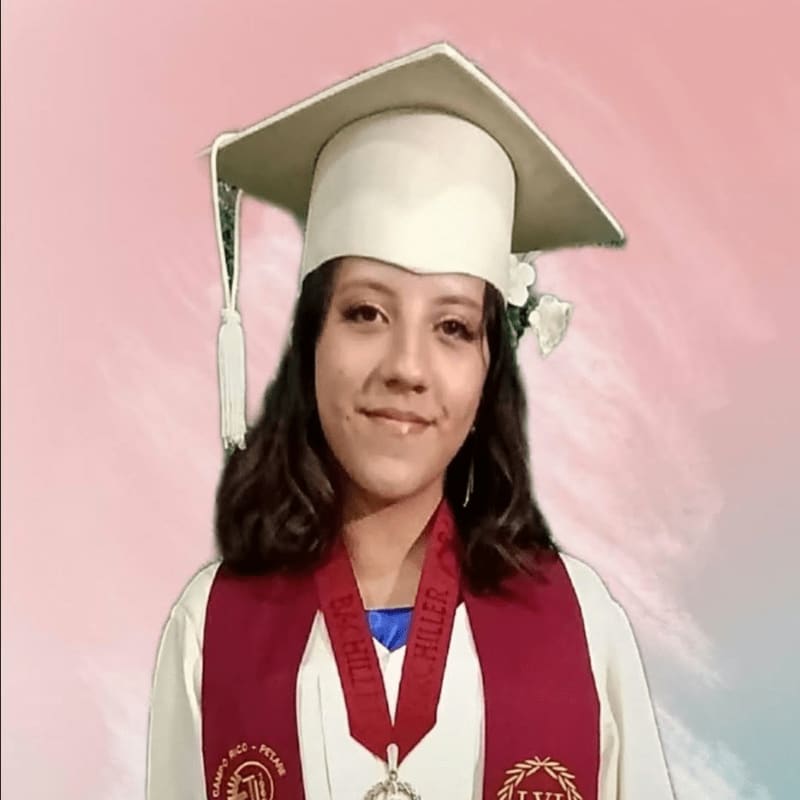 A young woman in a white graduation cap and gown with a maroon stole and medal poses against a soft pink and white gradient background.