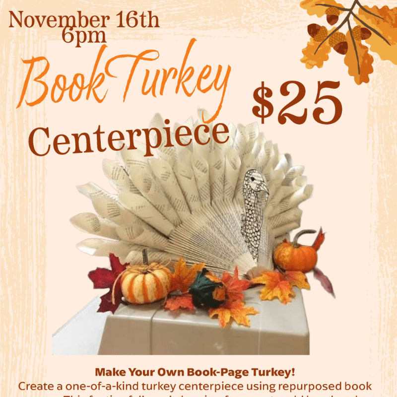 A paper turkey centerpiece made from book pages sits atop a white box surrounded by autumn leaves and pumpkins, set against a light beige background with event text and orange fall foliage.
