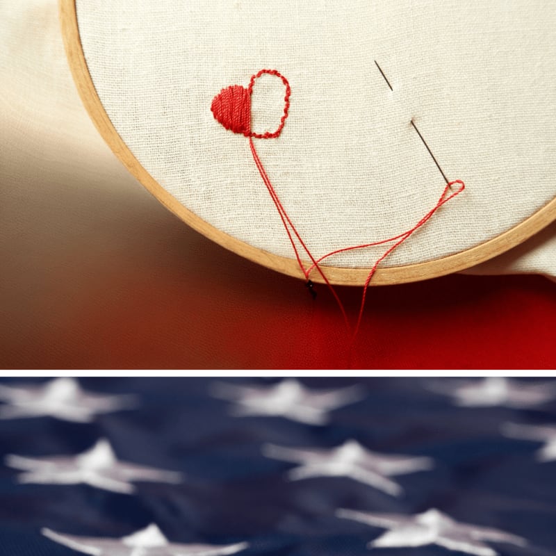 A needle and red thread forming a heart on white fabric in an embroidery hoop are positioned above a blurred blue background with white stars.