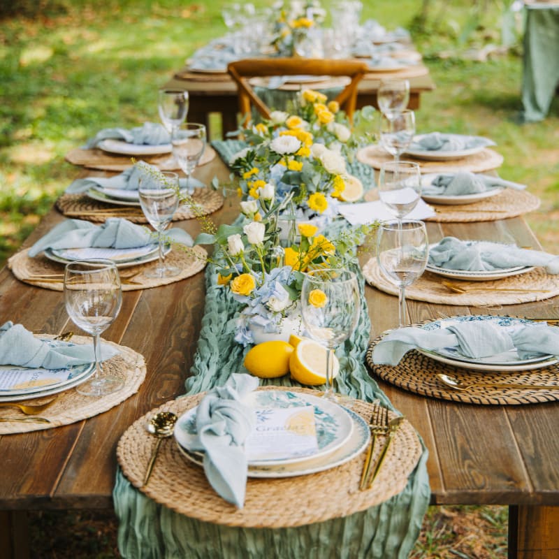 Outdoor table setting with floral centerpiece and lemons