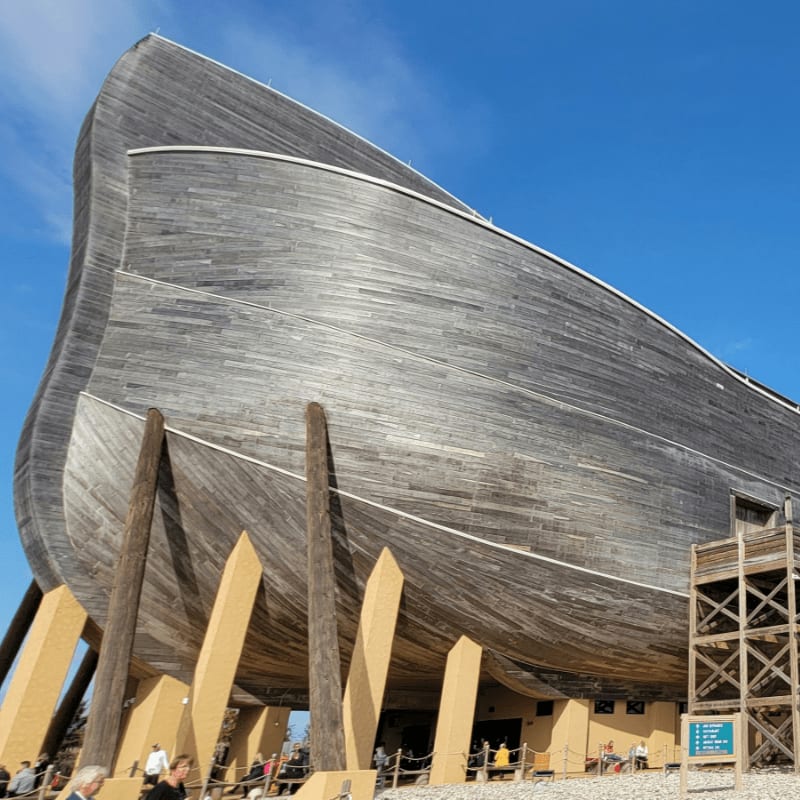 a large wooden boat sitting on top of a beach