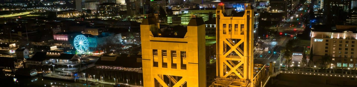 a view of a city at night from the top of a bridge