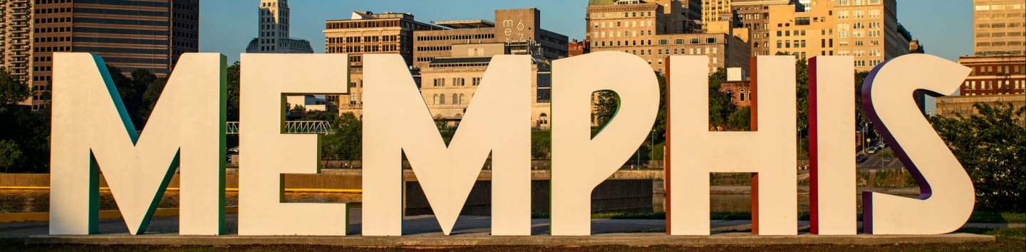Large white letters spelling "MEMPHIS" stand in the foreground against a backdrop of city buildings.