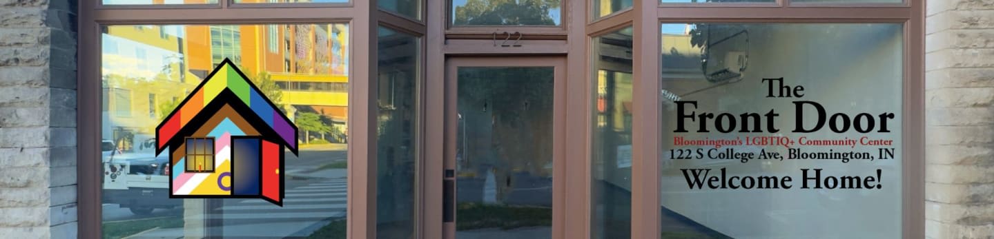 A rainbow-colored house logo is visible on the left side of the glass storefront, which displays "The Front Door" and "Welcome Home!" on the right.
