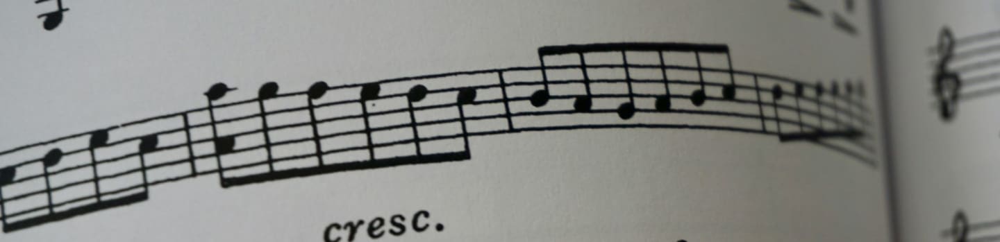 a close up of a book with musical notes
