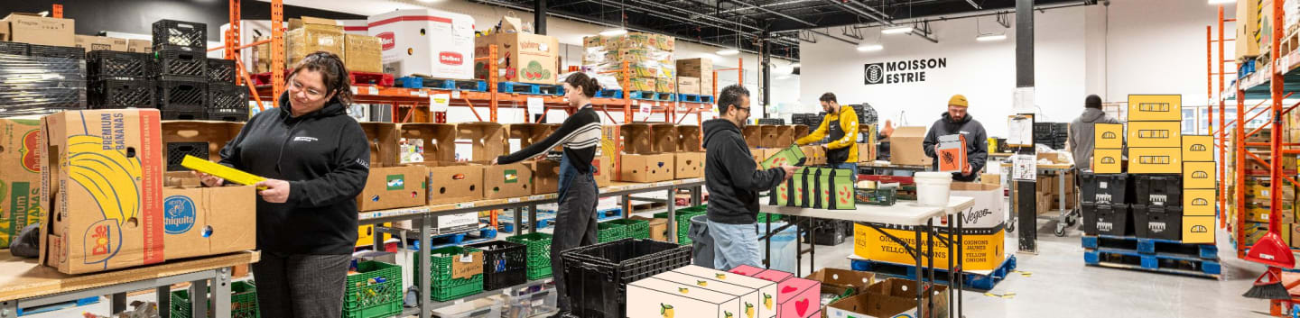 Volunteers sort and pack boxes of food in a warehouse filled with shelves of supplies.