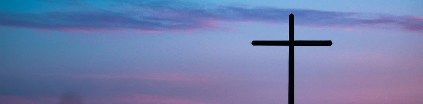 cross stand under purple and blue sky
