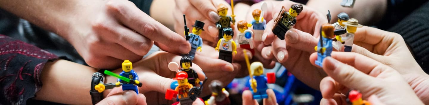 people holding miniature figures