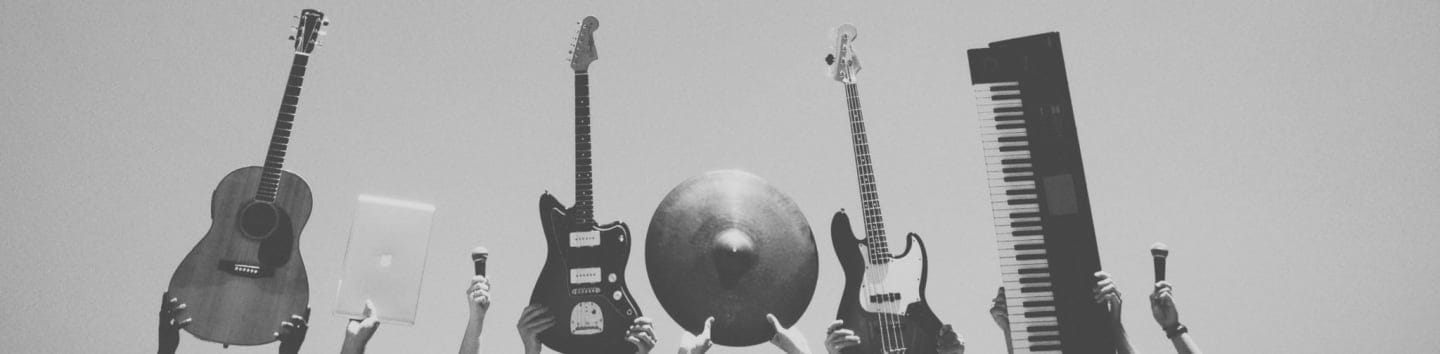 grayscale photo of people holding assorted music instruments