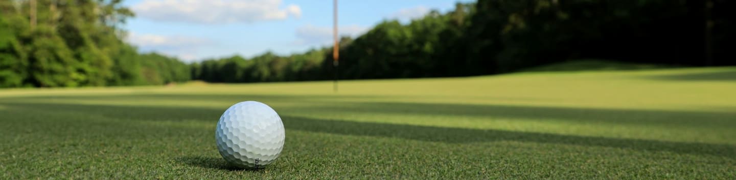a golf ball sitting on top of a green field