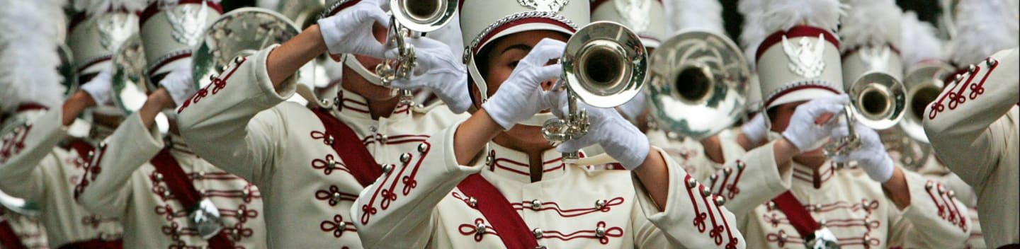 a marching band with white and red uniforms