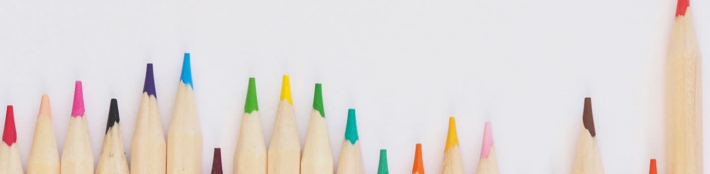 colored pencil lined up on top of white surface