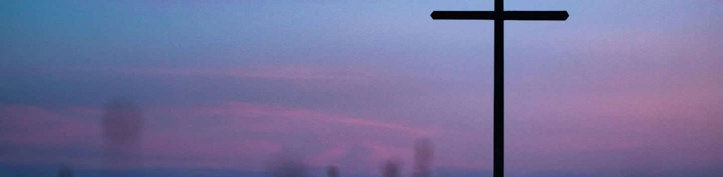 cross stand under purple and blue sky