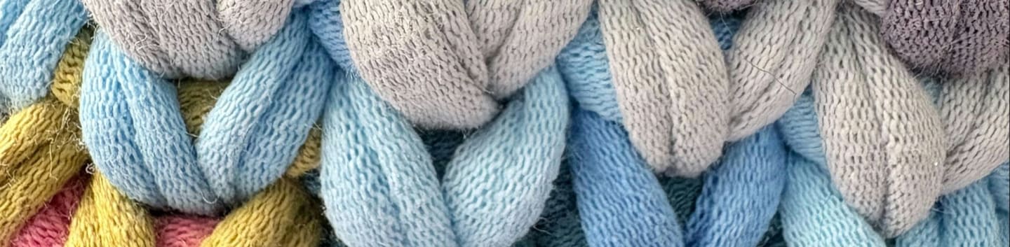 Close-up of chunky knit fabric in pastel colors