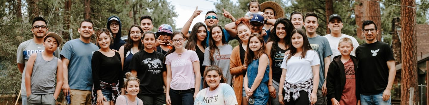 group of people taking photo near brown wooden tree