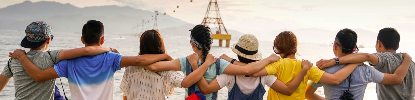 people holding shoulders sitting on wall