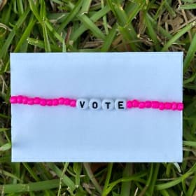 Neon pink glass bead VOTE bracelet item