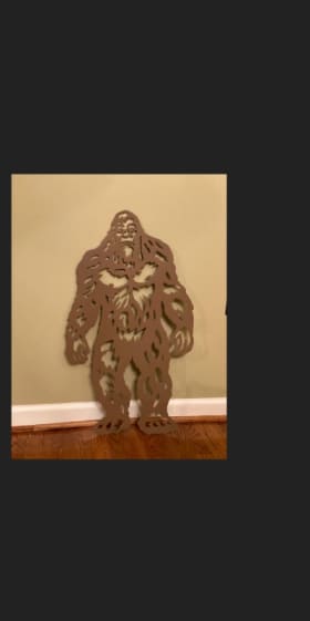 Item #31: Hand-cut Metal Art: Big Foot Approaching item