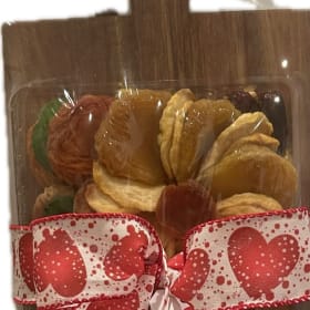 A Wooden board with dried fruit and nuts item