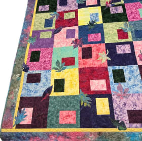 “Rustling Leaves appliquéd in colorful Batiks” Throw Quilt item