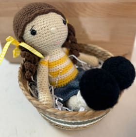 20. Yellow striped crochet doll item