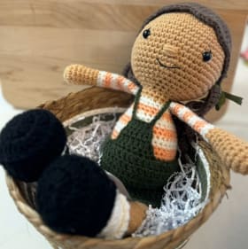 21. Orange striped crochet doll item