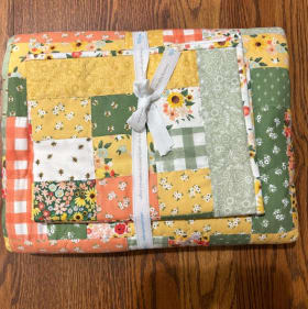 Handmade Quilt, 60" x 70" and includes small baby blanket item