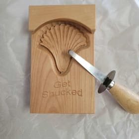 Oyster shucking board and knife item