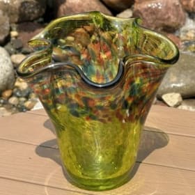 Small green bowl with colorful top and wide mouth item