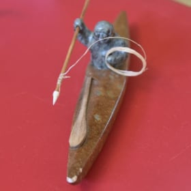 Carved Inuit hunter in kayak item