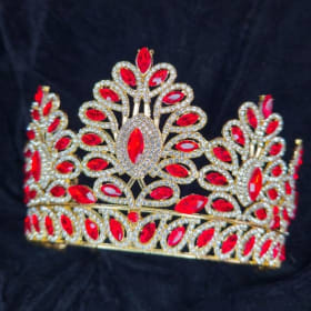 A dazzling crown adorned with numerous red and clear crystal item