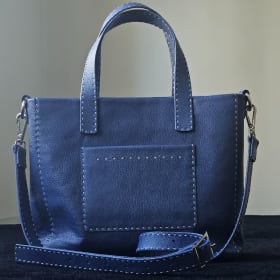 Medium leather tote with cross strap. Blue item