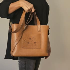 Brown tote with burned dogwoods item