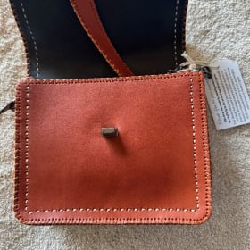 Brown leather purse with metal & leather strap item