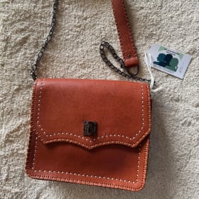 Brown leather purse with metal & leather strap item