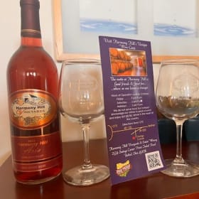 Two bottles of Harmony Hill wine and two HH wine glasses ($1 item
