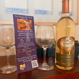 Two bottles of Harmony Hill wine and two HH wine glasses ($1 item