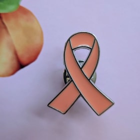 Peach Ribbon pin badge item