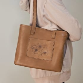 Large leather tote with burned flowers. Brown item